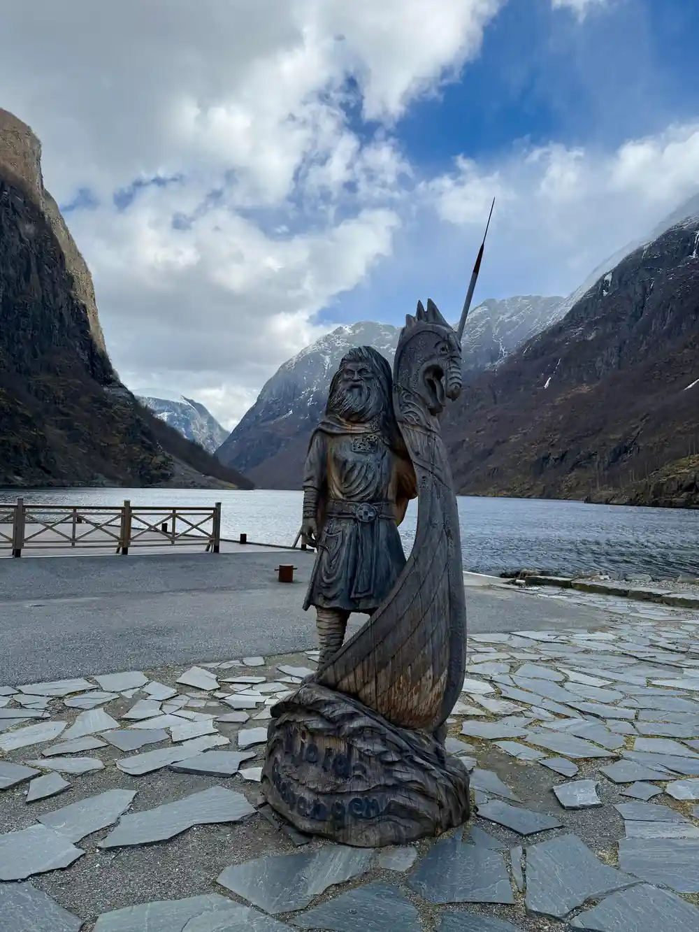 A carved wooden Viking figure on the quay at the head of the fjord