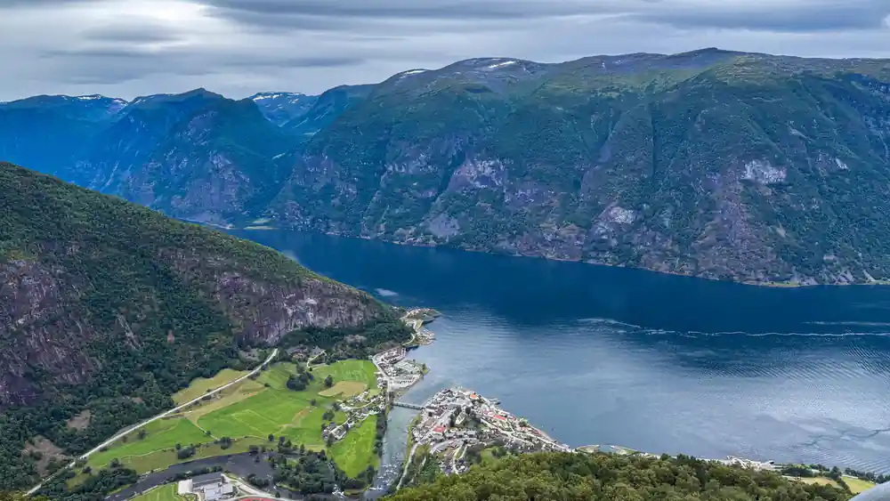 Farmland and a village on the flat ground where the fjord ends